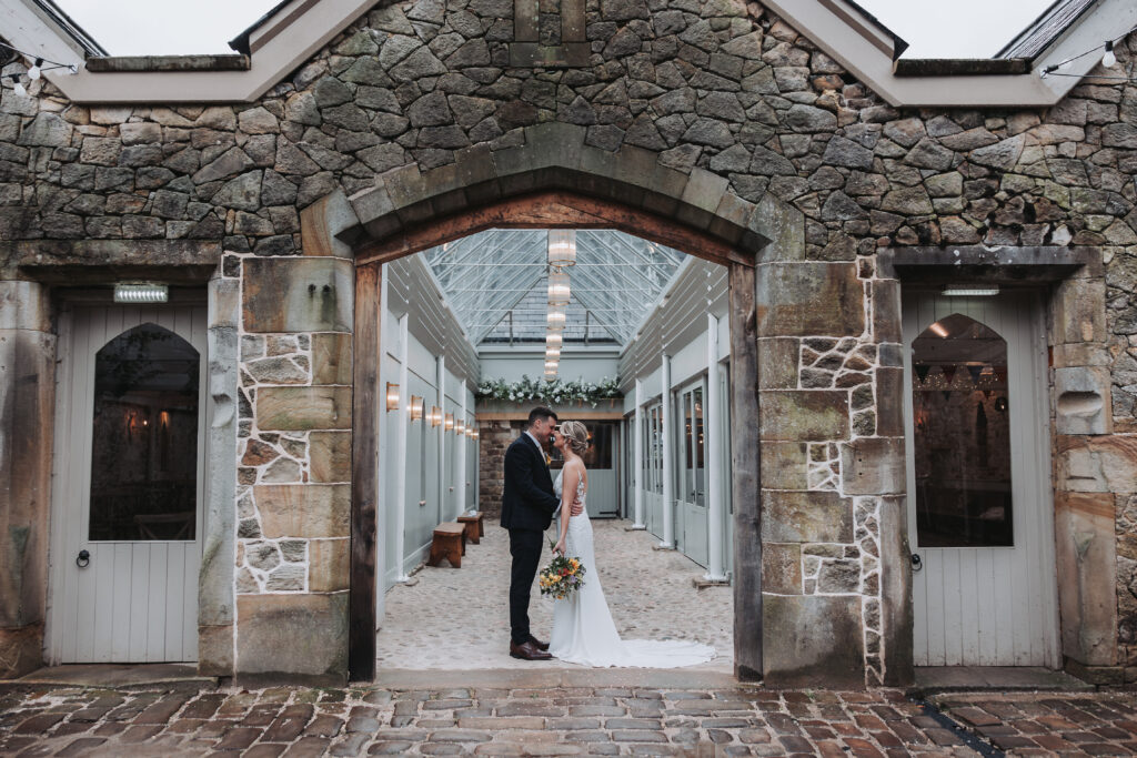 A couple in an archway at Wyresdale park