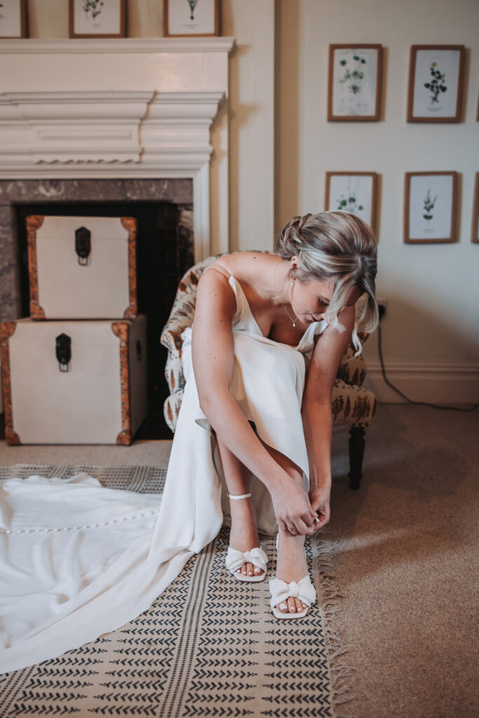 A bride putting on her shoes